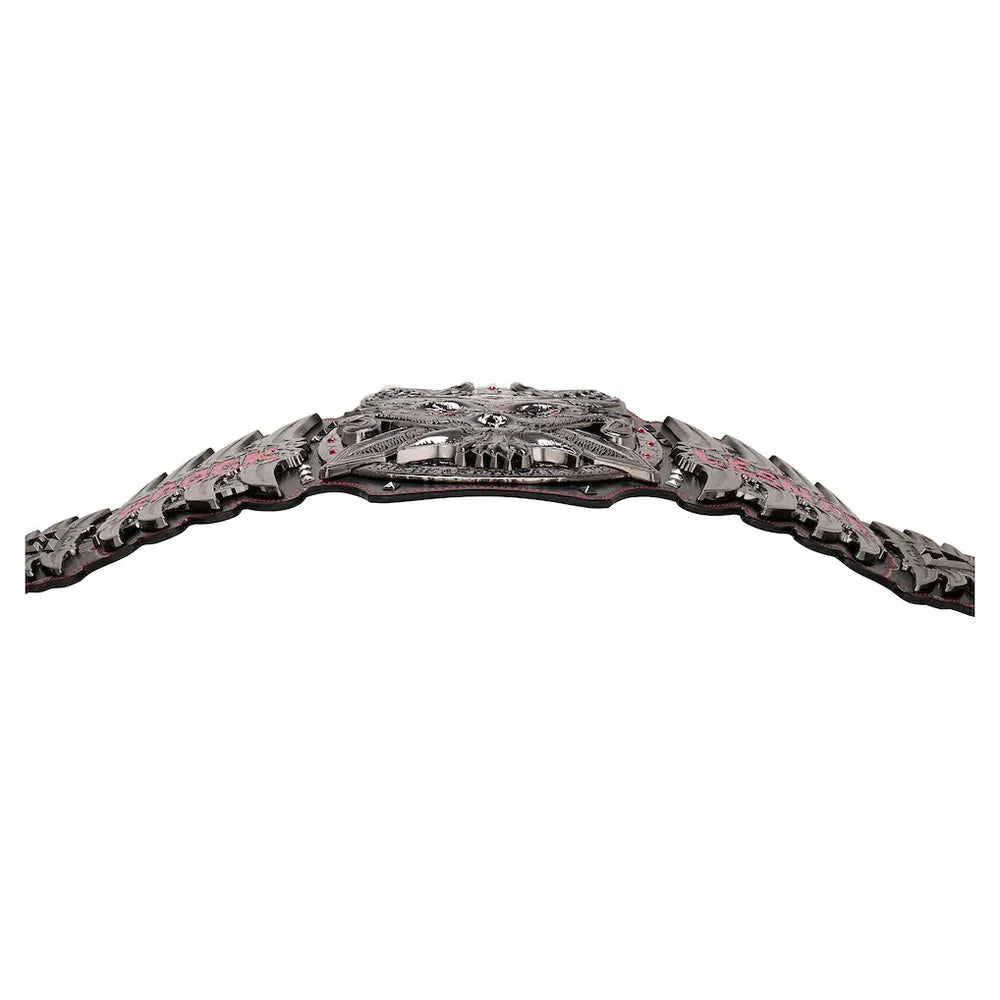 A wide, ornate black belt with a highly detailed, textured buckle featuring red and silver accents, photographed against a solid white background.