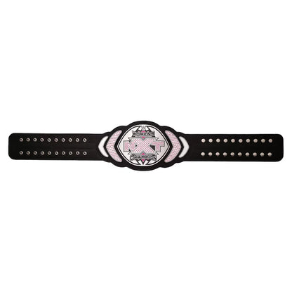 A black championship-style belt with a central oval plate featuring a pink ribbon and the words 'Breast Cancer Champion.' The belt has silver studs and a textured center panel on a plain white background.