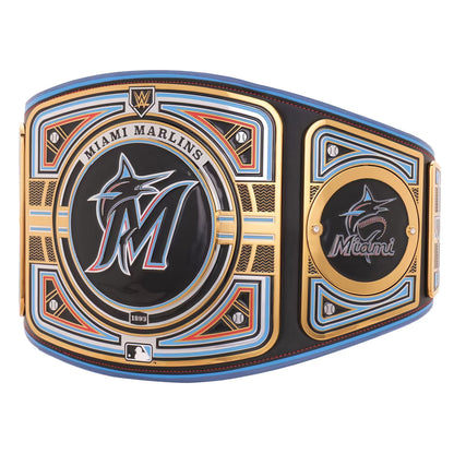 A Miami Marlins championship belt featuring a large central plate with the Marlins logo, a smaller logo plate on the side, and decorative gold, blue, and orange accents on a black background.