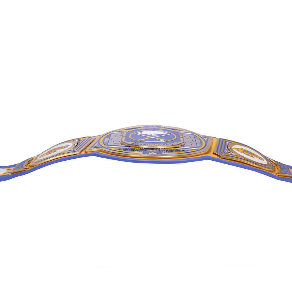 A close-up of a championship-style belt with a blue strap and gold-toned plates, shown against a plain white background.