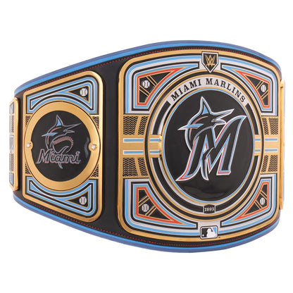 A Miami Marlins championship belt featuring a large central plate with the Marlins logo, a smaller side plate with the Marlins wordmark, and decorative gold, blue, and orange accents on a black background.