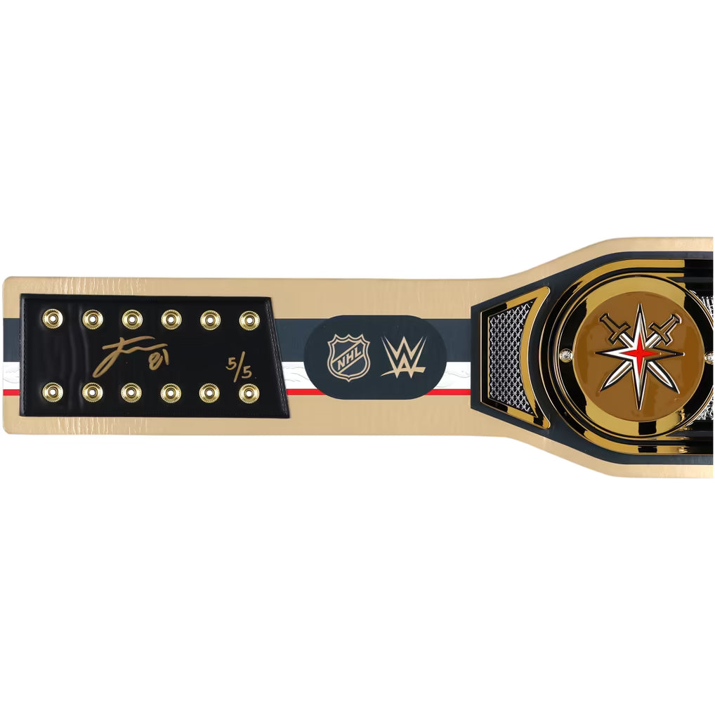 A WWE and NHL championship belt shown horizontally against a plain white background. The belt features a gold-toned metal frame, a black central plaque with the WWE and NHL logos, a signature on the left, and a circular gold-toned medallion with a red and white star on the right.