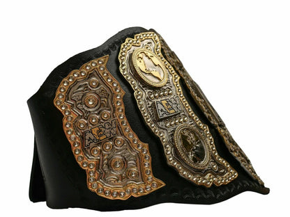 Decorative leather belt with intricate gold and bronze designs on a white background