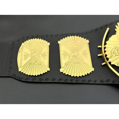 Gold championship belt plates with an eagle design, mounted on a black leather strap, shown against a dark background.