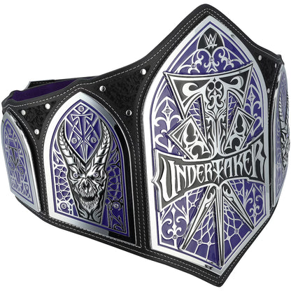 WWE Undertaker Championship belt featuring purple and silver arched panels with a skull and the Undertaker name, bordered by black leather straps with silver rivets.
