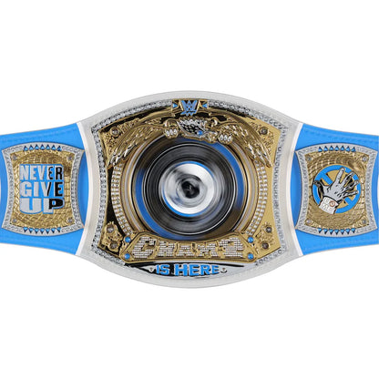 A custom WWE championship belt featuring a blue strap, gold and silver plates, and a central spinning metallic disc. The left plate reads 'NEVER GIVE UP' and the right plate features a hand graphic with 'WRESTLING' written below.
