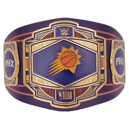 A Phoenix Suns WWE championship belt featuring a purple and gold design with the Suns basketball logo in the center, flanked by WWE and PHX branding.