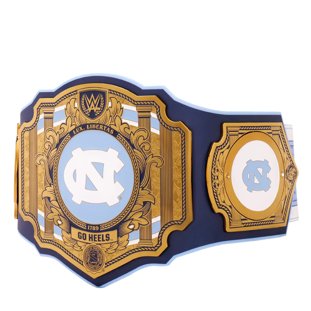 A replica of the WWE Women's Liberty Championship belt featuring the UNC Tar Heels logo, with navy blue and gold plates on a white background.