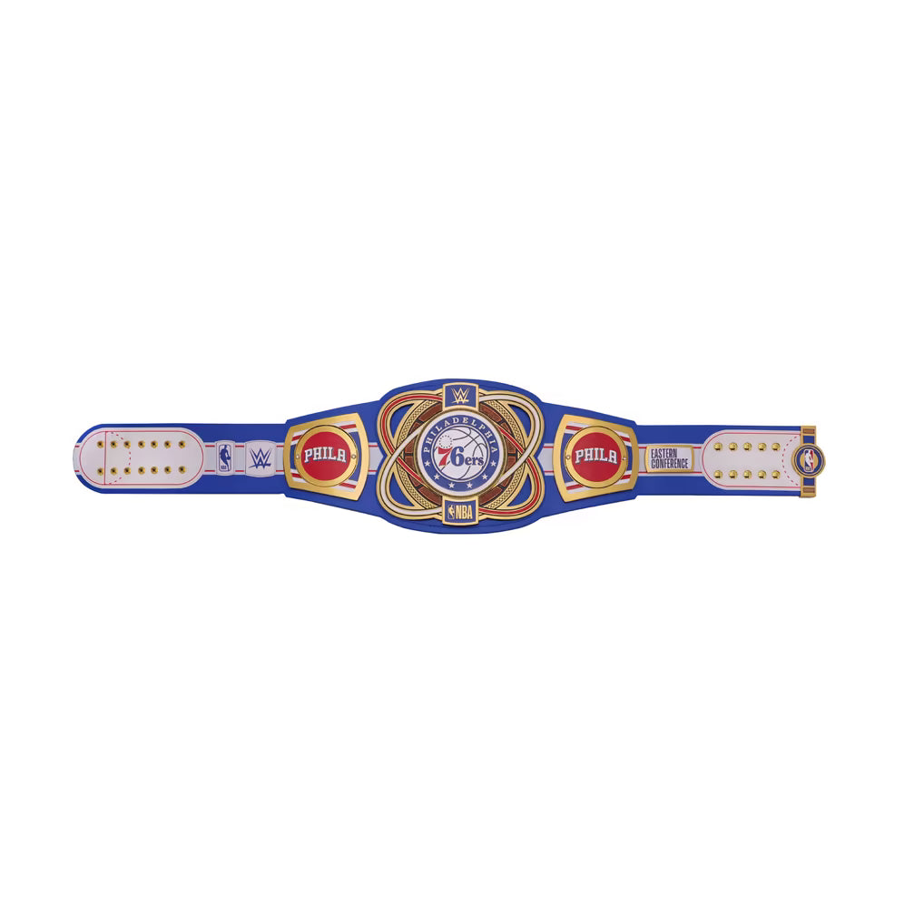 A WWE 76ers championship belt featuring a blue strap with gold and white details, a central gold and blue plate with the 76ers logo, and WWE and Philadelphia 76ers branding on both sides.