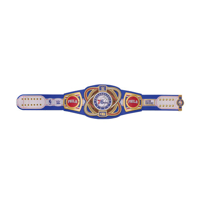 A WWE 76ers championship belt featuring a blue strap with gold and white details, a central gold and blue plate with the 76ers logo, and WWE and Philadelphia 76ers branding on both sides.