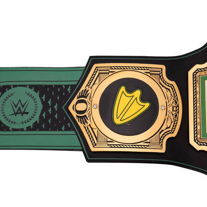 A close-up of a championship-style belt with a black strap, gold-tone ornate plates, green accents, and a yellow arrowhead emblem in the center. A WWE logo is visible on the left section of the strap.