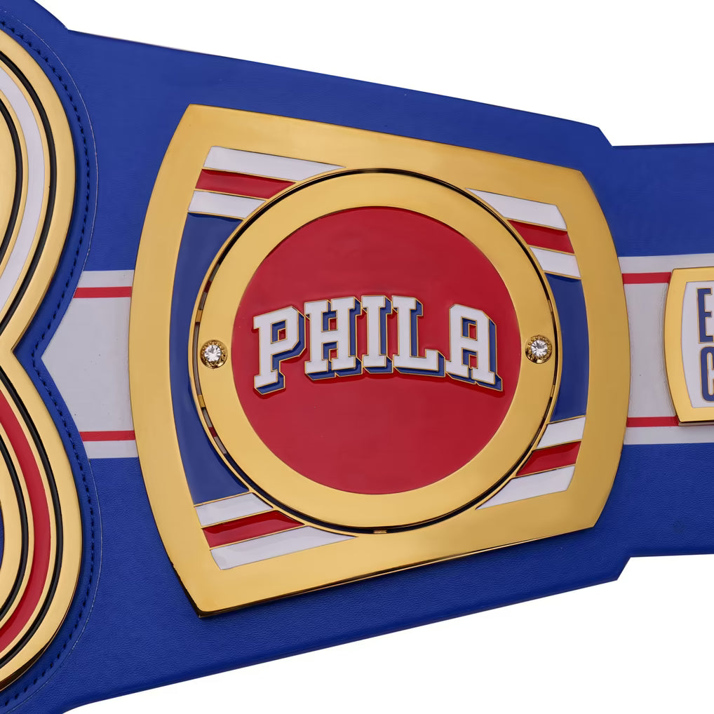 Championship belt with 'PHILA' on a red background