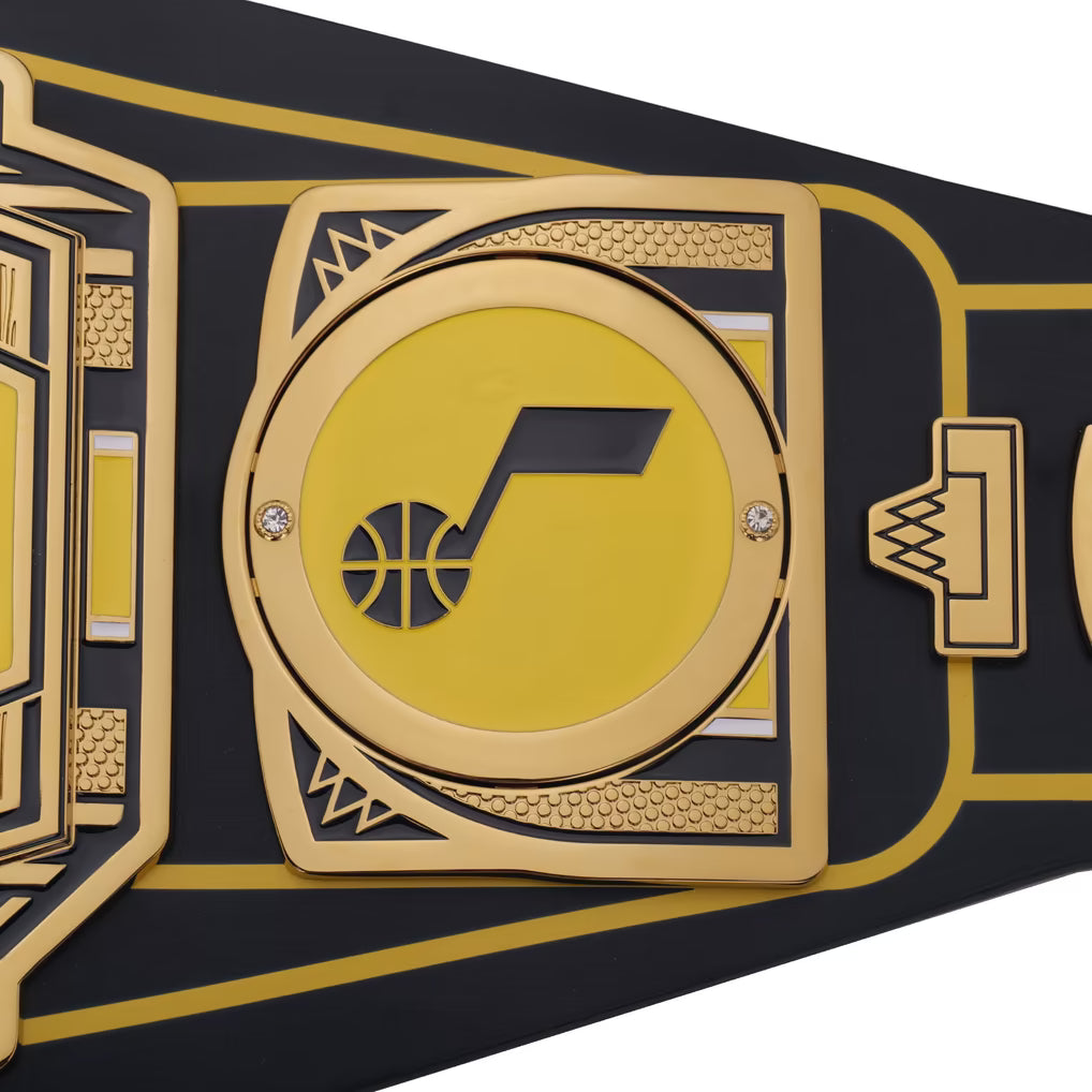 Black and gold championship belt with a central logo