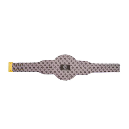A horizontal stretch strap with a gray and black geometric pattern, featuring a central circular section, a yellow connector on the left, and a black brand patch in the middle.