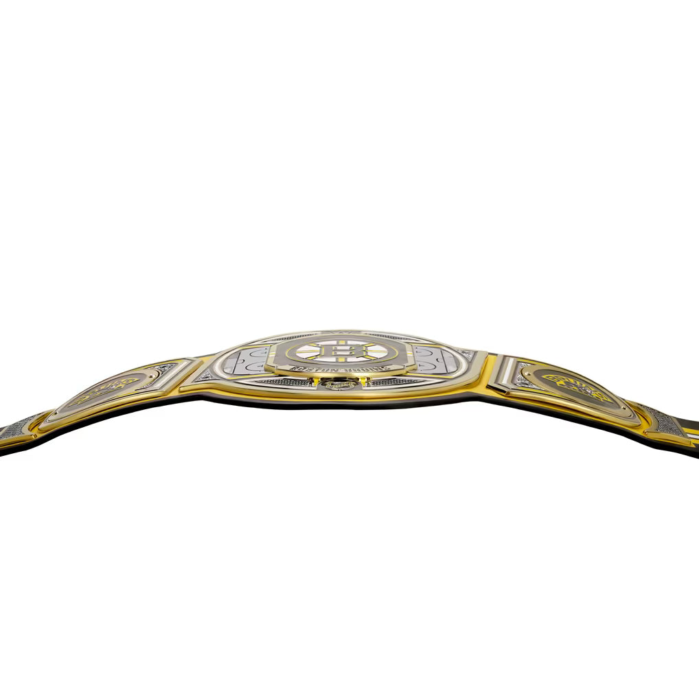 A championship belt with a silver and gold design, featuring a large central plate with a stylized 'H' logo and the words 'HONOR SHAMROCK', flanked by two side plates with circular emblems, set against a plain white background.