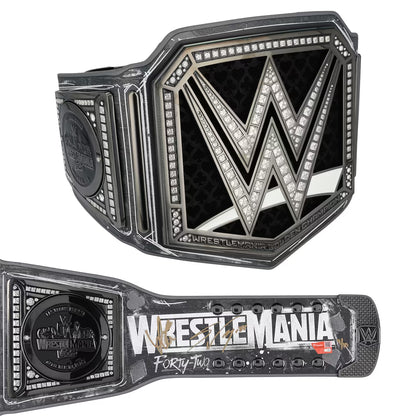 A WWE WrestleMania 42 championship belt shown from two angles on a plain white background: the large front plate with the WWE logo and the matching strap laid horizontally below.