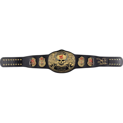 A black championship belt with a large central gold plate featuring a skull and the words 'Cruel It All Championship,' flanked by smaller gold emblems and a signature on the right side, photographed on a plain white background.