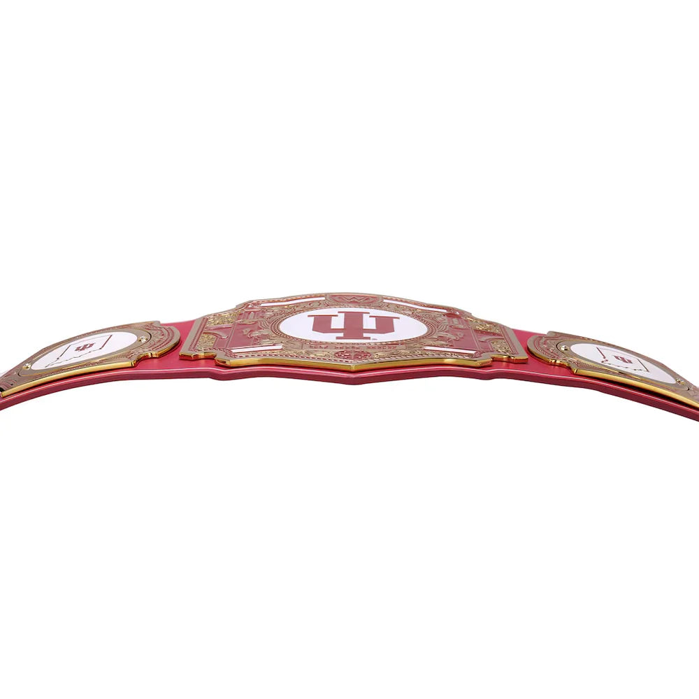 A red and gold championship-style belt with a large central plate featuring a red 'IU' logo and smaller side plates, photographed on a plain white background.