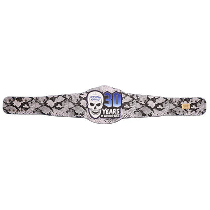 A championship-style belt with a black and white snakeskin pattern, featuring a central skull emblem and blue and white '30 YEARS' text, photographed on a plain white background.
