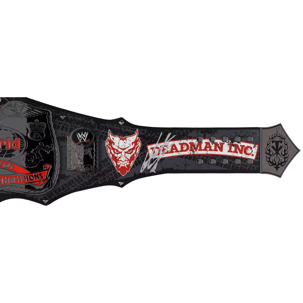 A WWE Deadman Inc. World Champion replica belt featuring a black textured background with red and white logo details, a red devil face graphic, and a silver WWE logo plaque, shown against a plain white background.