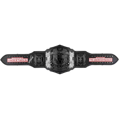 A black and silver WWE Championship belt with red and white text, displayed horizontally against a plain white background.
