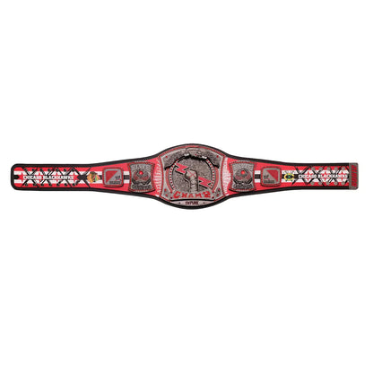 Red championship belt with a central emblem on a white background