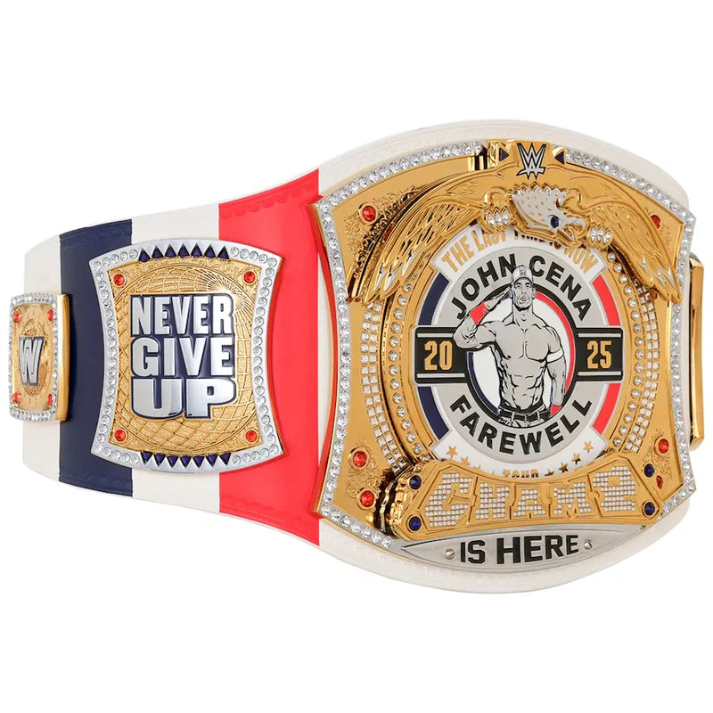 A WWE John Cena Championship belt featuring a white strap with red and navy blue stripes, a large gold central plate with a portrait of John Cena, and smaller gold and white plates reading 'NEVER GIVE UP' and 'CHAMPIONSHIP IS HERE'.