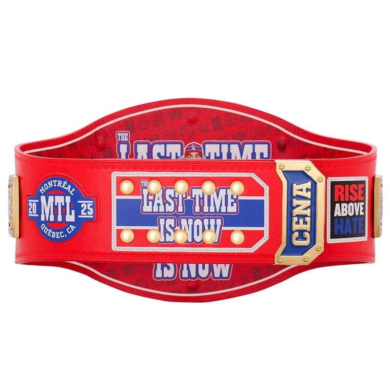 A red championship belt featuring multiple colorful patches and text, including 'LAST TIME IS NOW', 'CENA', and 'RISE ABOVE HAITI', shown against a plain white background.