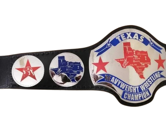 A novelty Texas Heavyweight Wrestling Champion belt featuring a large silver and white main plate with a red and blue map of Texas, flanked by two smaller circular plates on a black strap.