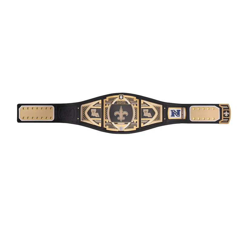 A black and gold championship belt with multiple plates, featuring a central fleur-de-lis emblem and a blue 'N' logo on one side, displayed flat against a white background.