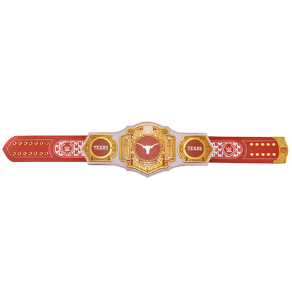 A toy championship belt featuring red and gold sections with white details, including the words 'TEXAS' and a longhorn logo in the center, shown against a plain white background.
