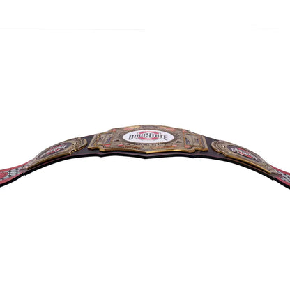 A professional wrestling championship belt, specifically the IWGP World Heavyweight Championship, featuring a large central gold-toned plate with red and white lettering, flanked by two smaller gold-toned plates on a black strap, shown against a plain white background.