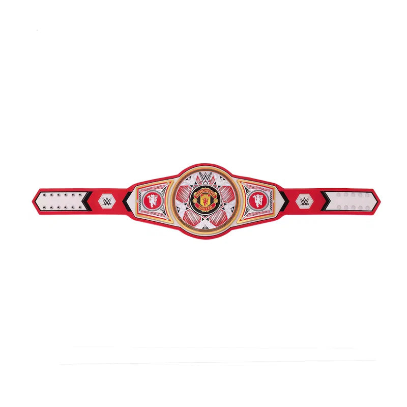 A red and white WWE championship belt replica with a central circular medallion featuring the Manchester United crest, flanked by WWE logos on the sides, shown against a plain white background.