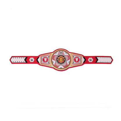 A red and white WWE championship belt replica with a central circular medallion featuring the Manchester United crest, flanked by WWE logos on the sides, shown against a plain white background.