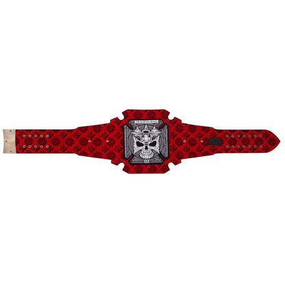 A red and black patterned belt with a central silver and black skull emblem, displayed flat against a white background.